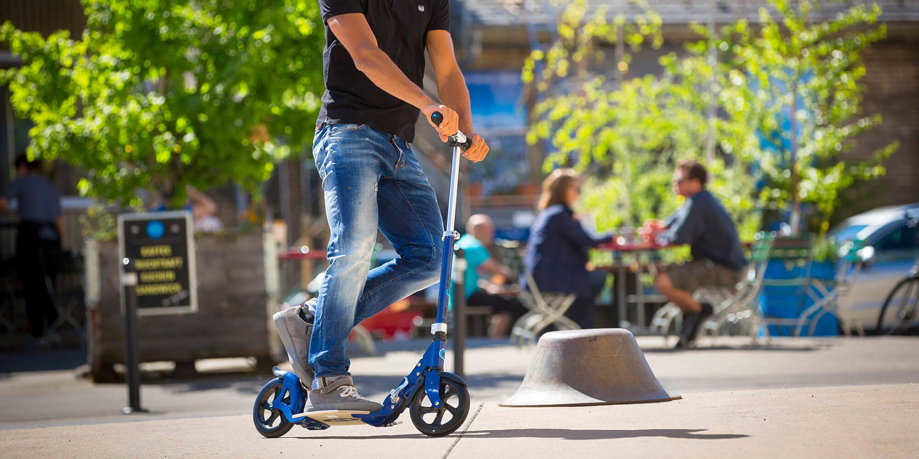 Man riding Micro Flex adult kick scooter with flexible deck