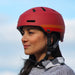 Woman wearing Bern Macon 2.0 bike helmet in Matte Retro Rust