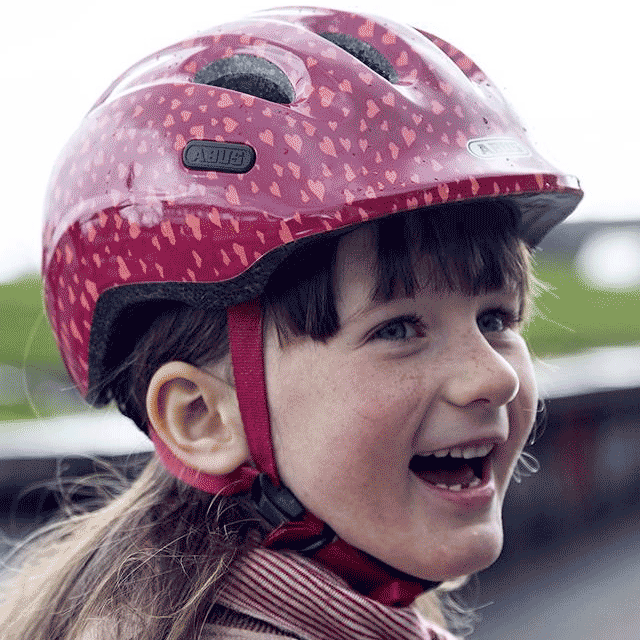 Young girl wearing Abus Smiley 2.0 bicycle helmet for children