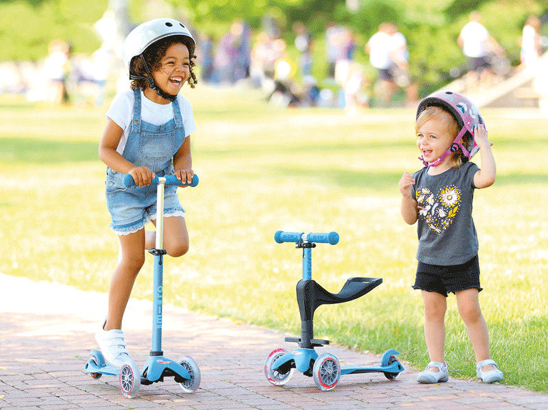 Girls riding Micro Mini 3in1 Deluxe plus in two different modes