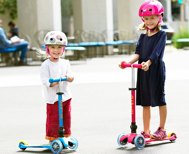 young girls riding Mini Micro Foldable kick scooters