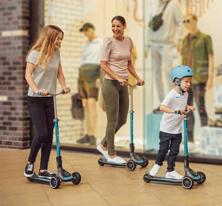 Family riding the Globber Ultimum Three Wheel Kick Scooter