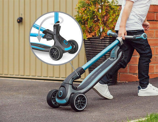 Kid pulling the Globber Ultimum Three Wheel Kick Scooter in trolley mode