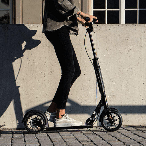 woman riding Micro Metropolitan Black kick scooter