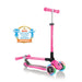 Globber Primo Lights foldable kick scooter, folded and unfolded view, in neon pink