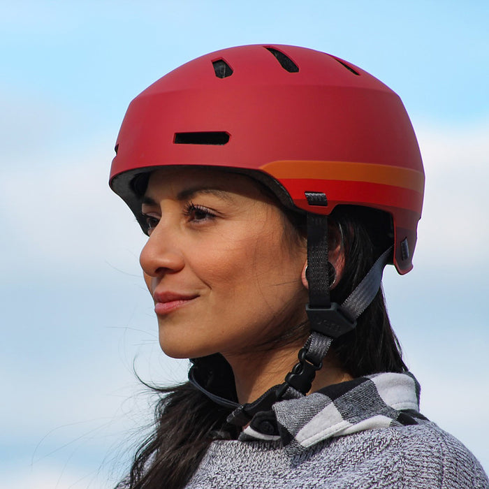 Woman wearing Bern Macon 2.0 bike helmet in Matte Retro Rust